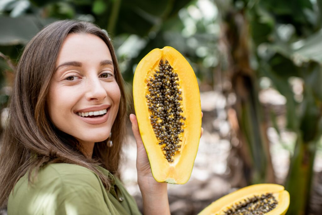 Portrait of a woman with papaya fruit